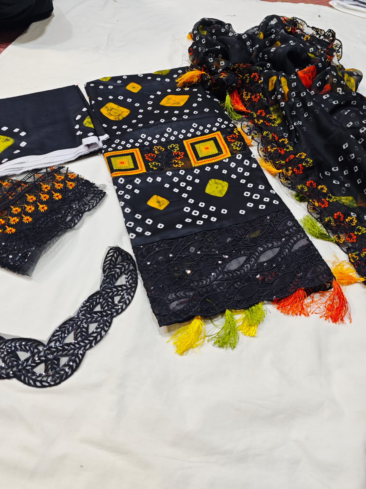 Black Chunri fabric from Danish Cloth, showcasing intricate traditional embroidery and vibrant patterns on high-quality textile.