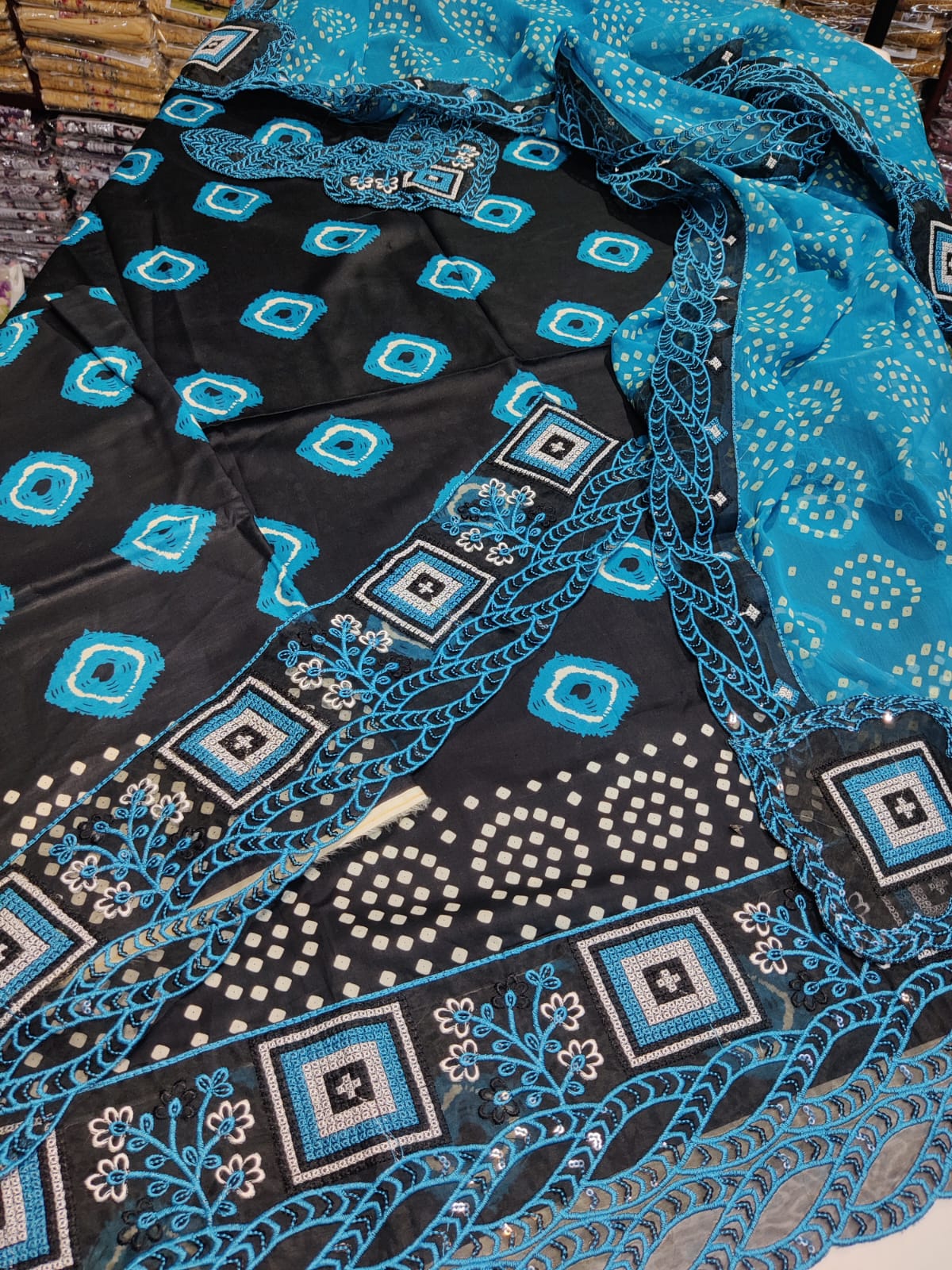 Aneelas Chunri in blue and black by Danish Cloth, showcasing vibrant traditional fabric with intricate pattern details.