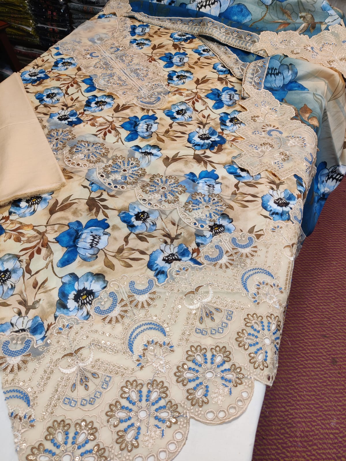 Aagn Daman lawn dupatta in vibrant fabric with intricate embroidery, displayed on a hanger showing detailed patterns and lightweight material.