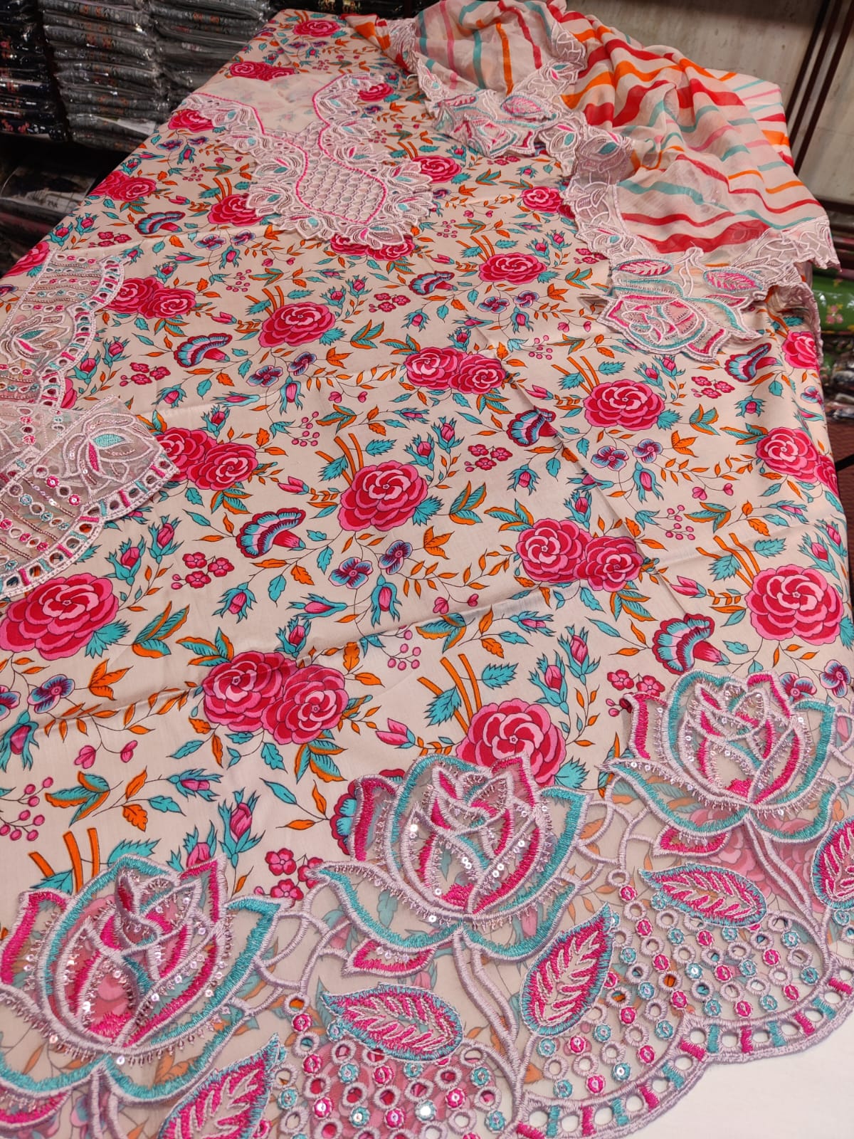 Naba Aneela's Danish Cloth product with colorful, patterned fabric featuring intricate designs and vibrant embroidery.