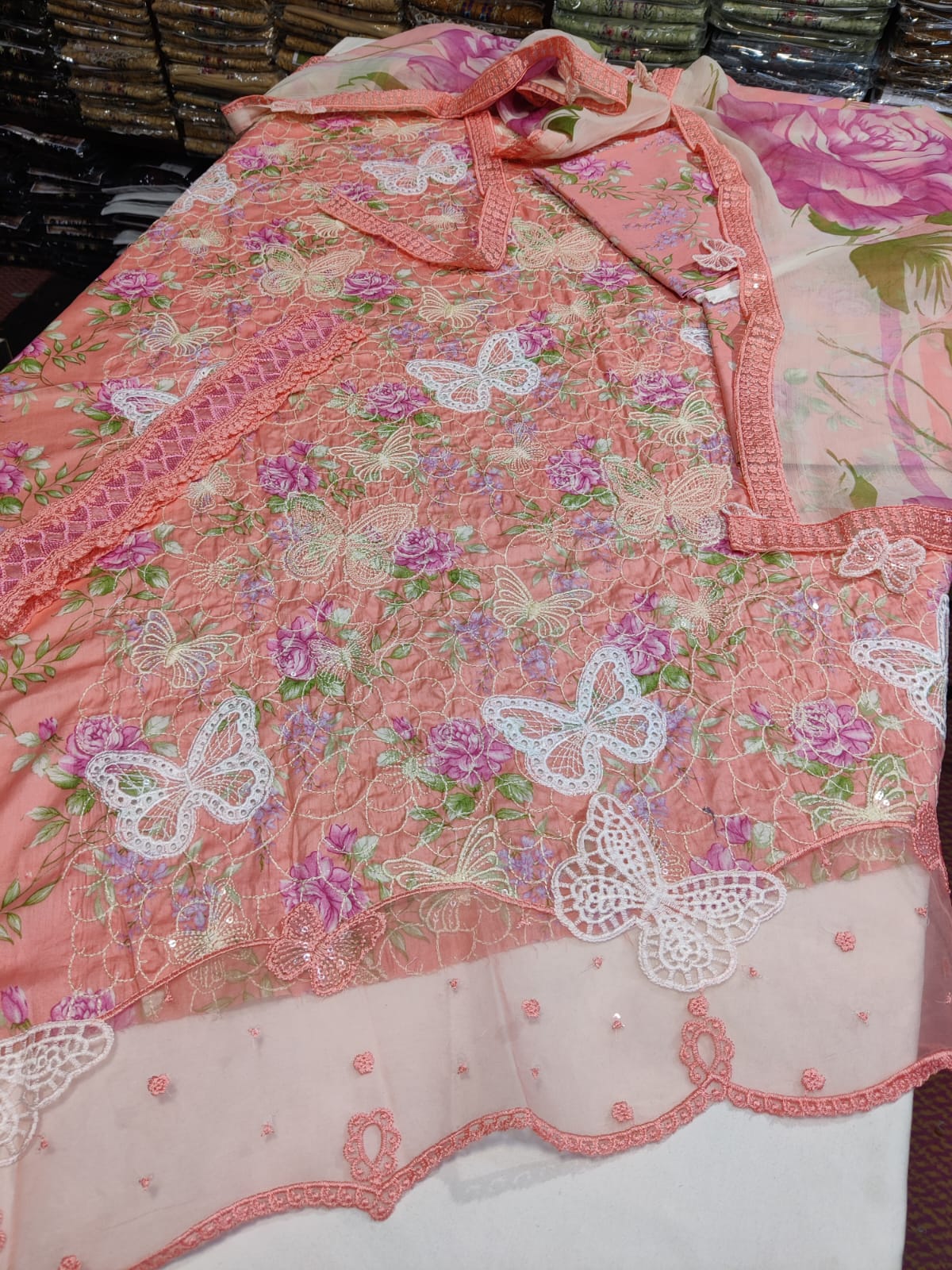 Pink butterfly-patterned dress from Danish Cloth's Maria.b new collection, featuring vibrant colors and delicate design.